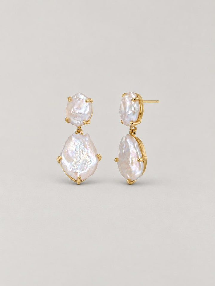 TT Original earrings jewelry on a pearl gray background