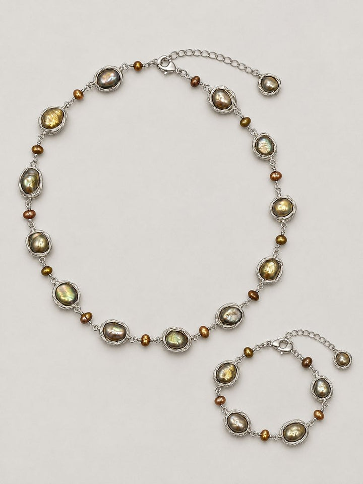 TT Original sets jewelry on a pearl gray background
