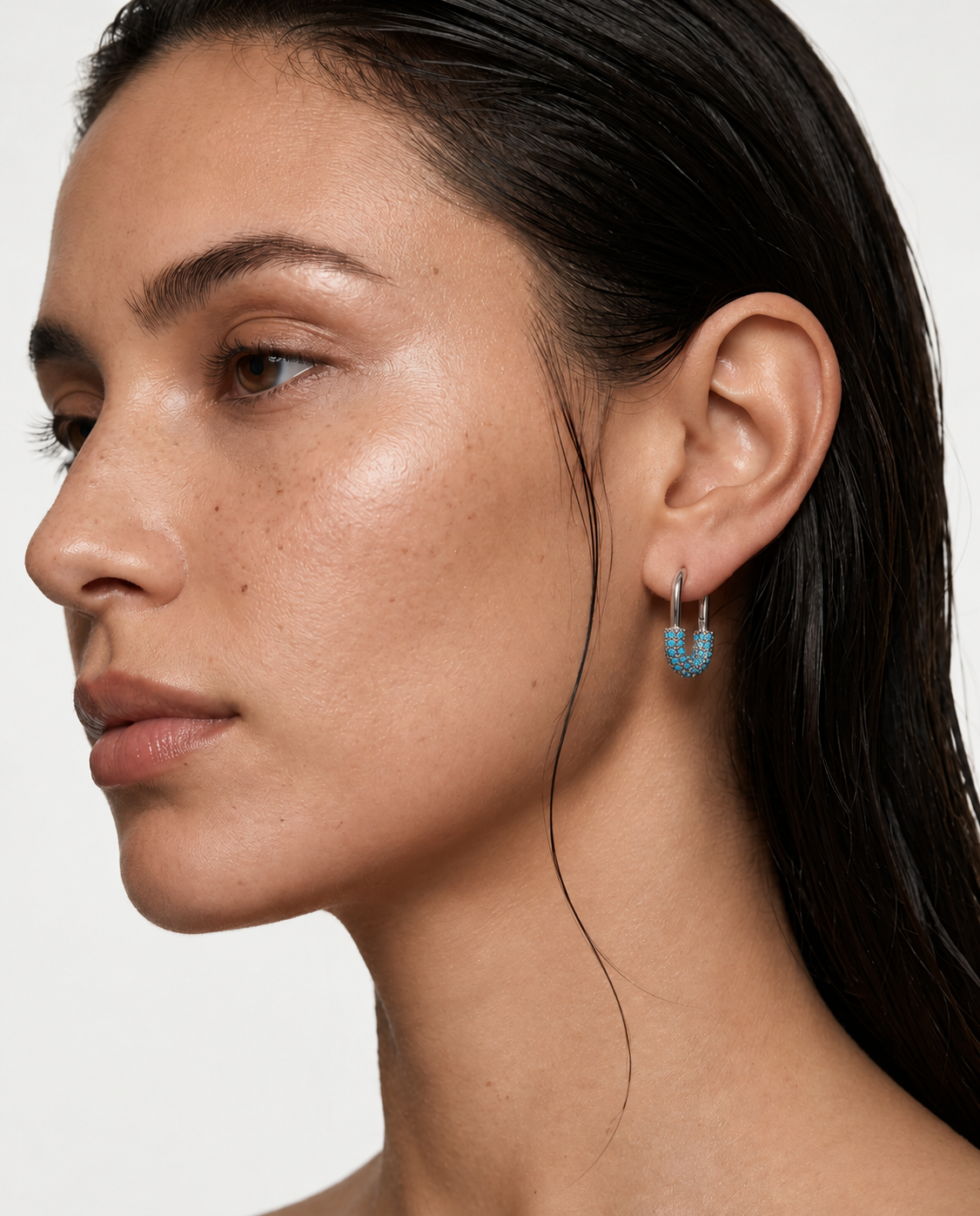 woman wearing turquoise hoop earrings