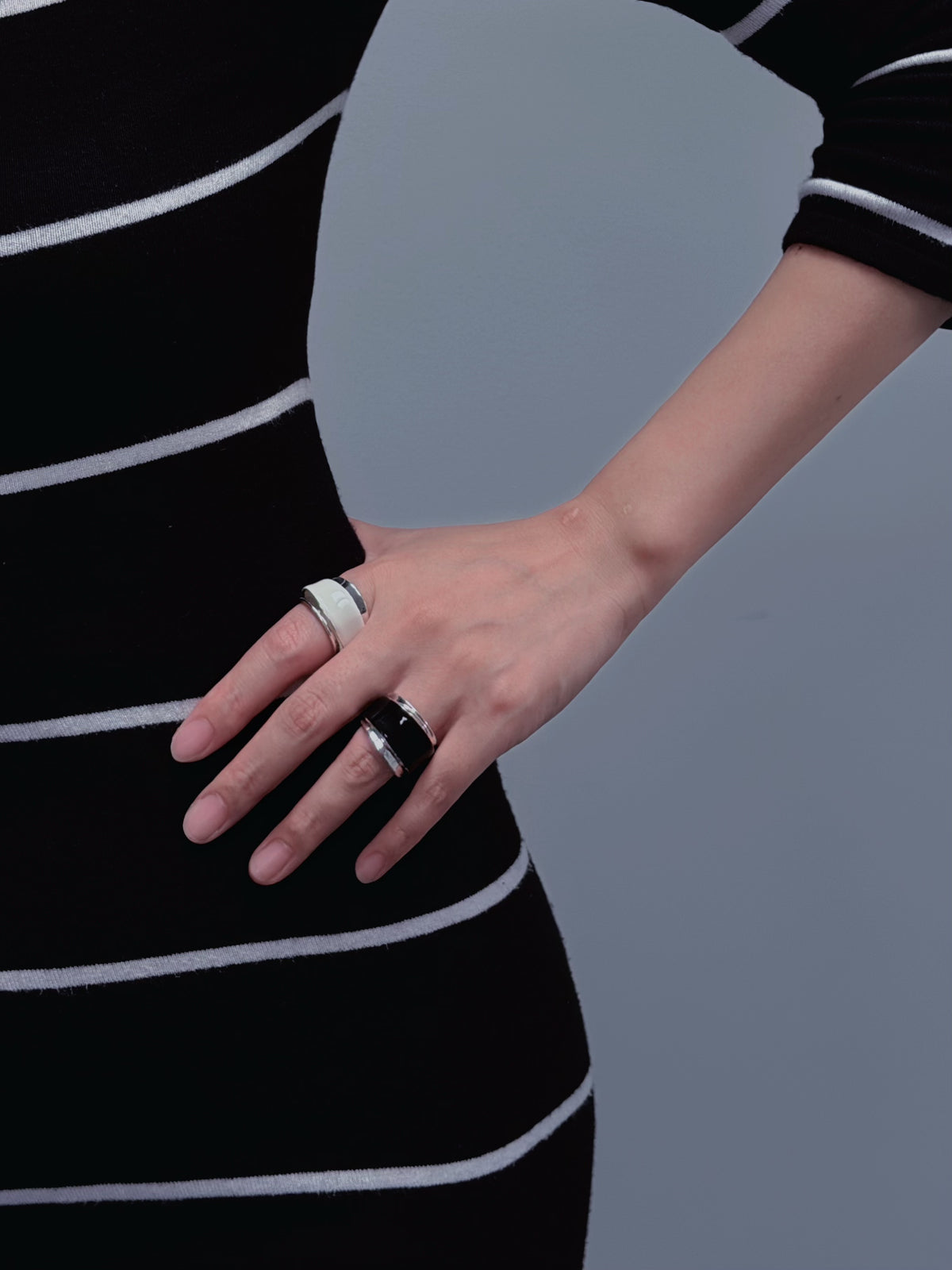 Two-tone enamel wide ring worn on hand