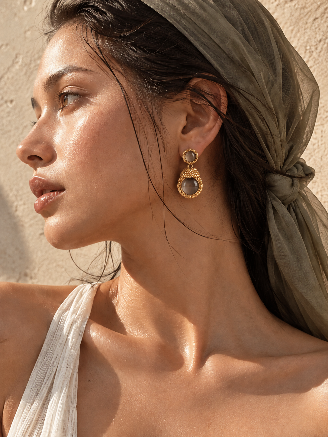 woman wearing vintage gold cat eye earrings