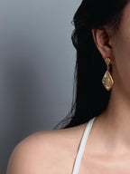 woman wearing vintage gold drop earrings