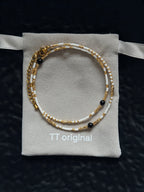Close-up of white beads arranged along a delicate necklace