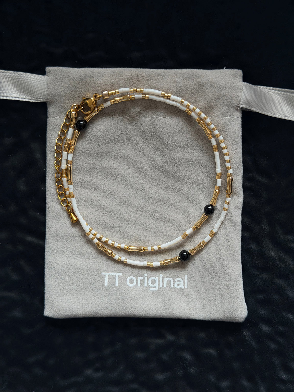 Close-up of white beads arranged along a delicate necklace