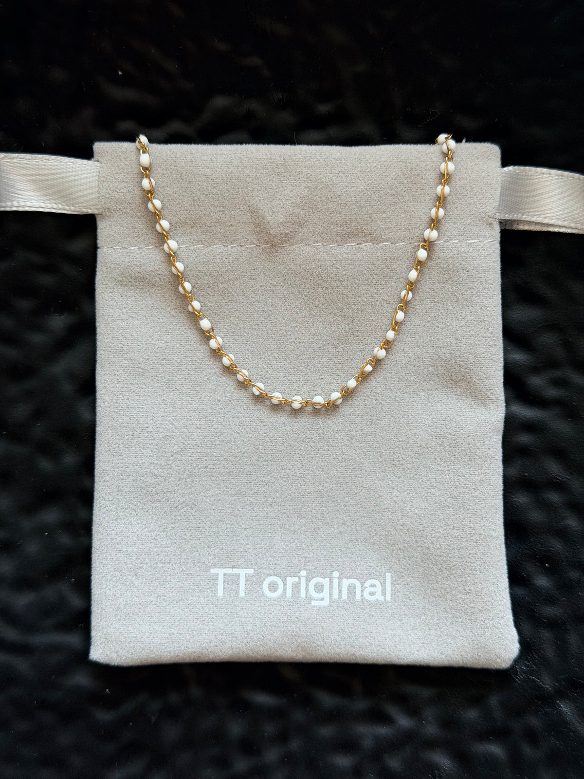 White enamel details on gold chain necklace