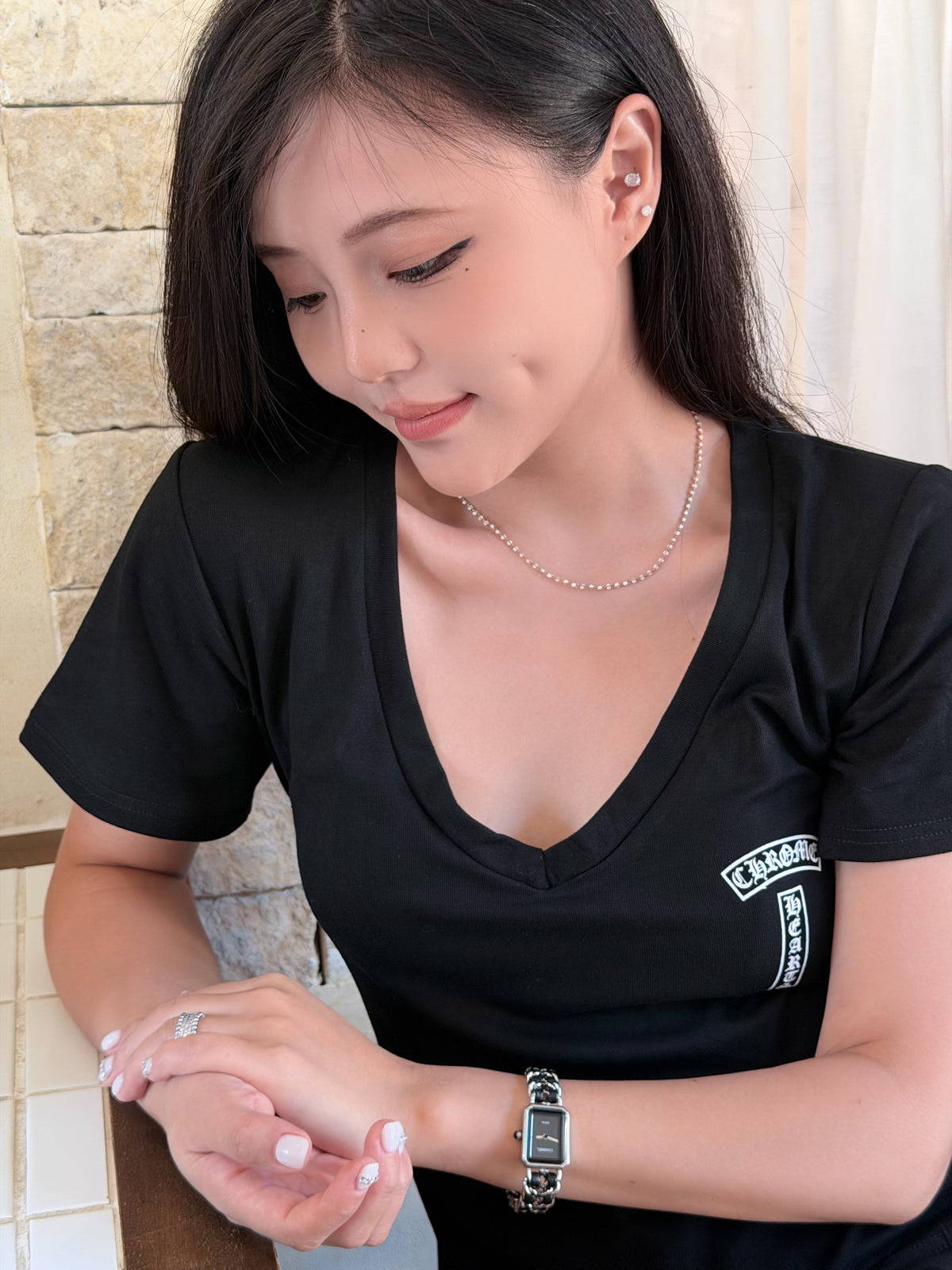 White enamel gold necklace worn around the collarbone