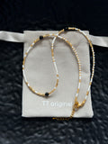 White and gold beaded necklace with minimalist design