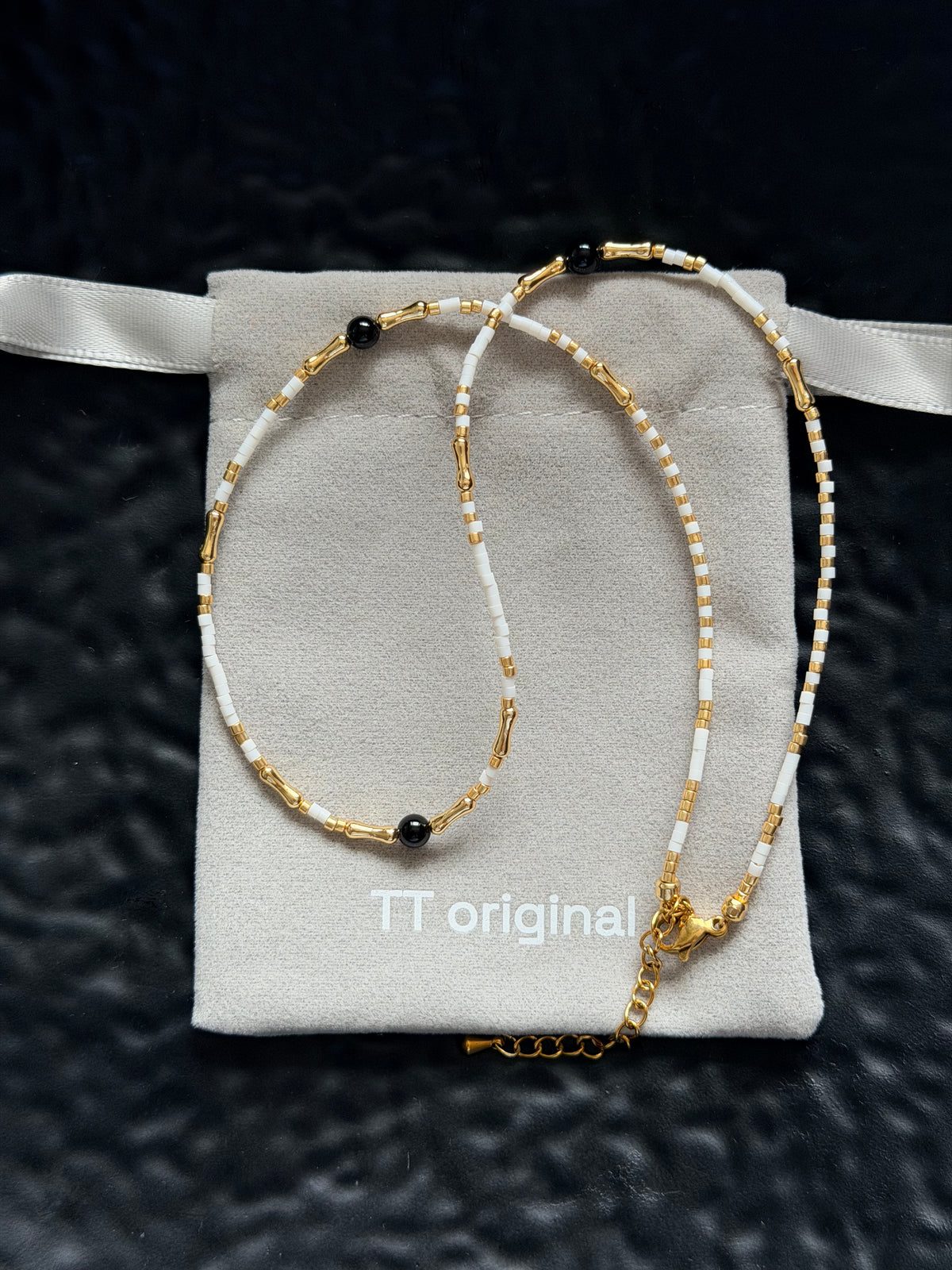White and gold beaded necklace with minimalist design