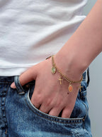 Woman wearing a vintage gold cross bracelet