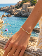 Woman wearing a vintage pearl and seashell bracelet