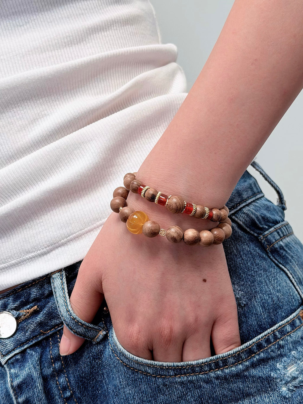 Yellow chalcedony and agarwood bracelet layered with other jewelry